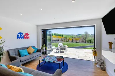 a living room with a couch and a table at 5 Bed in Pant-y-Dwr oc-w30200 in Pant-y-dwr