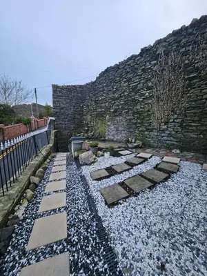 a garden with rocks and a stone wall at Bryn Aber-The House on the Hill in Llangollen