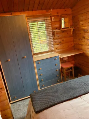 a bedroom with a desk and a bed in a cabin at Fernleys Place in Trawsfynydd
