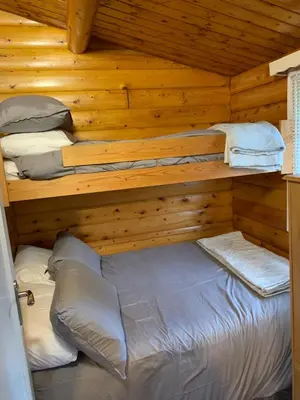 a bedroom with two bunk beds in a log cabin at Fernleys Place in Trawsfynydd