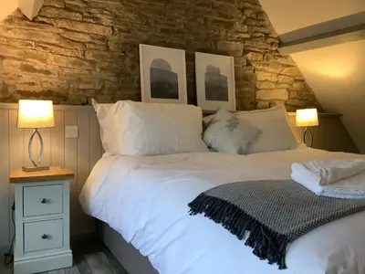 a bedroom with a large white bed with two lamps at The Royal Oak, Gladestry in Gladestry