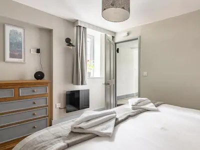 a bedroom with a bed and a dresser and a television at The Royal Oak, Gladestry in Gladestry