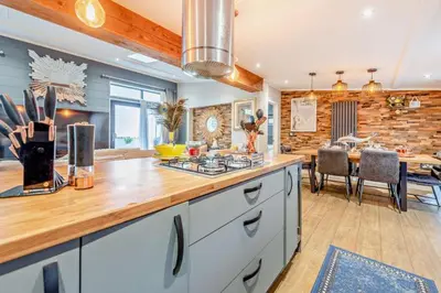 a kitchen with a counter top and a dining room at Coogee View Lodge in New Quay