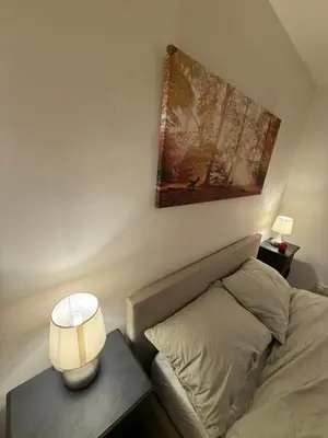 a bedroom with a bed and a table with a lamp at Meole Brace room in Meole Brace