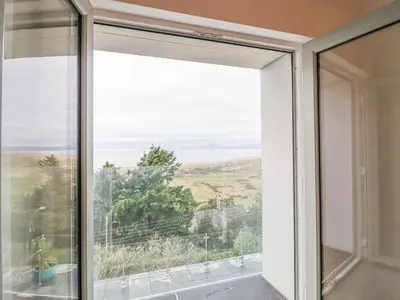 a window with a view of the ocean at Aelfor in Harlech