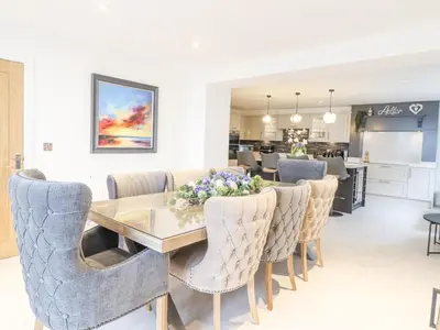 a dining room with a table and chairs at Aelfor in Harlech