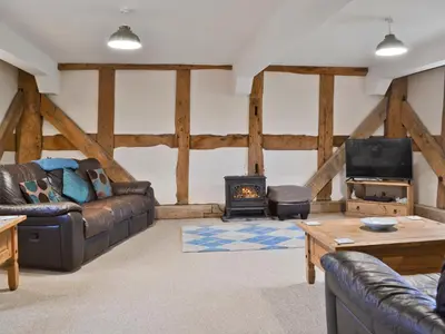 a living room with a couch and a stove at The Olde Granary - E4298 in Halston
