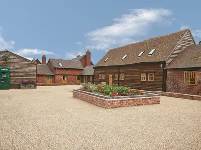 a group of buildings with flowers in a courtyard at Piglets Place - E4300 in Halston