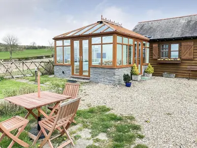 a house with a picnic table and a greenhouse at Stevannah - E5287 in Snead