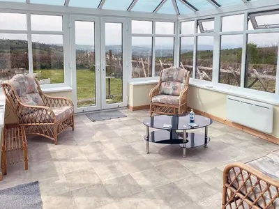 a room with two chairs and a table and windows at Stevannah - E5287 in Snead