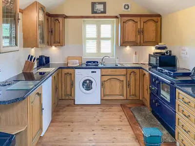 a kitchen with a washer and dryer in it at Stevannah - E5287 in Snead