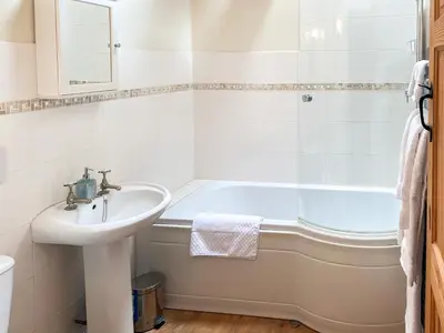 a bathroom with a sink and a bath tub at Stevannah - E5287 in Snead