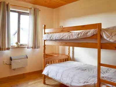 two bunk beds in a room with a window at Ithon Bank - Hw7478 in Penybont