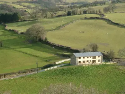 an aerial view of a farm building in a field at Cwm Corn Barn - Hw7662 in Mochdre