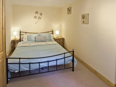 a bedroom with a large bed in a room at Cefnaire Isaf in Newtown