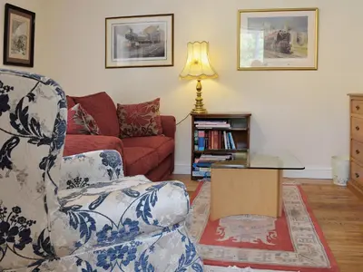 a living room with a couch and a chair at Porter's Lodge in Glyn-Dyfrdwy