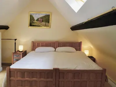 a bedroom with a large bed with two pillows at Porter's Lodge in Glyn-Dyfrdwy