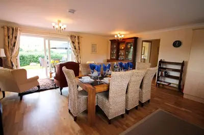 a dining room with a table and chairs at Aberceiro Bungalow in Aberystwyth