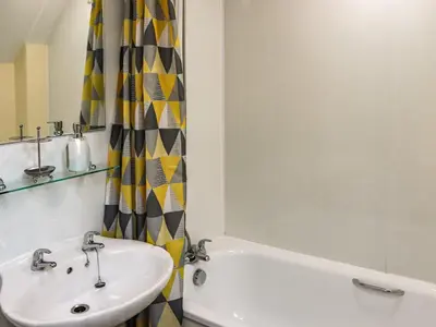 a bathroom with a sink and a bath tub at Hirnant - Uk48512 in Bala