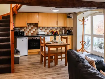 a kitchen and dining room with a table and chairs at Hirnant - Uk48512 in Bala