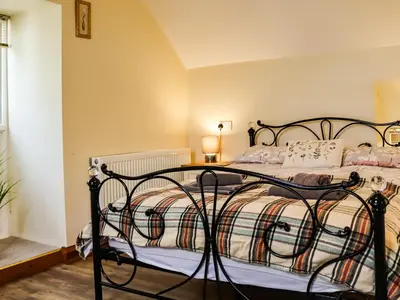 a bedroom with a bed with a wrought iron frame at Hirnant - Uk48512 in Bala