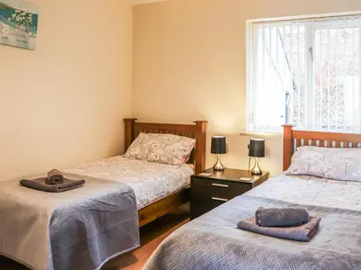 a bedroom with two beds and a window at Berwyn - Uk48507 in Bala