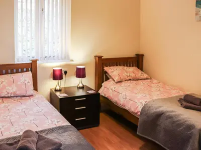 a bedroom with two beds and two lamps on a night stand at Arenig - Uk48508 in Bala
