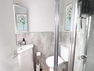 a bathroom with a shower and a toilet and a sink at Golygfa'r Orsaf Snowdonia National Park in Bala