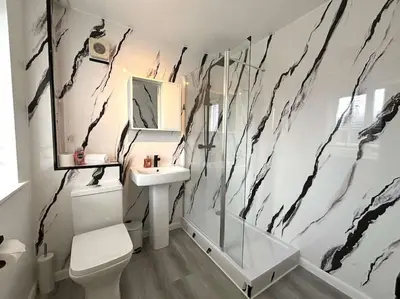 a bathroom with a toilet and a sink and a mirror at Shrewsbury Stayscape - Modern & Spacious 3BR - Family & Business Ready for 7 by Parydise Properties in Bicton