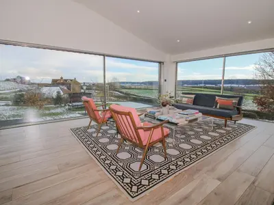 a living room with a couch and a table and chairs at 1 Little Broomcroft in Shrewsbury