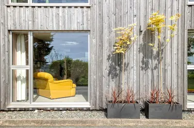 a yellow couch sitting inside of a building at 1 Little Broomcroft in Shrewsbury