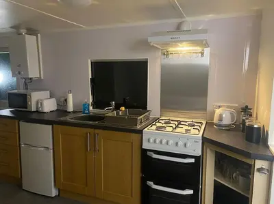 a kitchen with a stove and a sink at Fabulous Hot Tub with Views! in Llanfair Caereinion