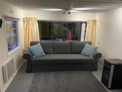 a living room with a couch and a window at Fabulous Hot Tub with Views! in Llanfair Caereinion