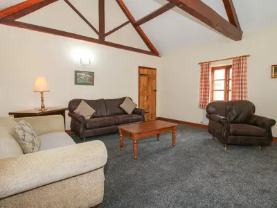 a living room with couches and chairs and a table at Walton Maisonette in Craven Arms