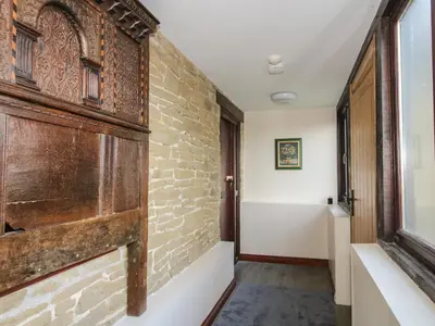 a hallway with a brick wall and a window at Walton Maisonette in Craven Arms