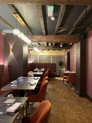 a dining room with long tables and chairs at Yak & Yeti in Shrewsbury