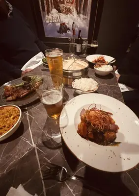 a table topped with plates of food and drinks at Yak & Yeti in Shrewsbury