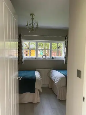 a bedroom with two beds and a window at Dog & Family Friendly Private Cottage in Orleton in Orleton