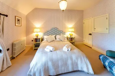 a bedroom with a bed with two towels on it at The Garden Cottage in Craven Arms