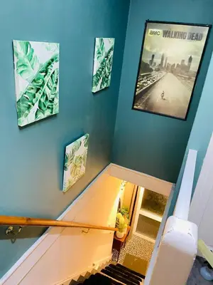 a room with a staircase with a movie on the wall at Sy3 Shrewsbury in Shrewsbury