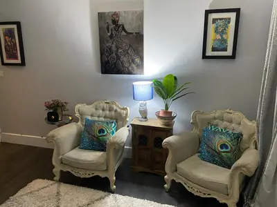 two chairs and a table with a lamp in a room at Sy3 Shrewsbury in Shrewsbury