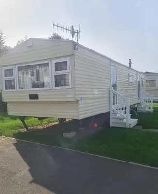 a mobile home with a porch and a staircase at 3 Bed Caravan - Sleeps 6 - Pets - Parking - Wifi in Borth