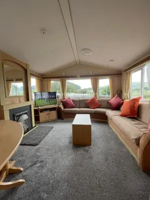 a living room with a couch and a tv at The Perfect Escape 2 Bedroom Static Caravan Pet Friendly in Aberystwyth