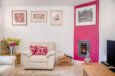 a living room with a chair and a fireplace at 2 Bed in Woofferton oc-b29941 in Woofferton