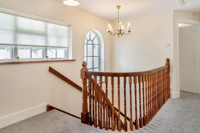 a staircase in a home with a chandelier at 3 Bed in Scethrog oc-h30013 in Scethrog
