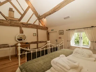a bedroom with a bed with white towels on it at Evenjobb Court Farmhouse in Presteigne