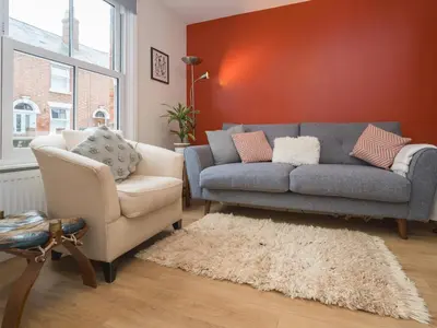 a living room with a couch and a chair at Colourful homely 2 bed terrace - Pass the Keys in Shrewsbury