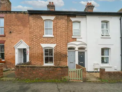 a red brick house with a blue door at Colourful homely 2 bed terrace - Pass the Keys in Shrewsbury