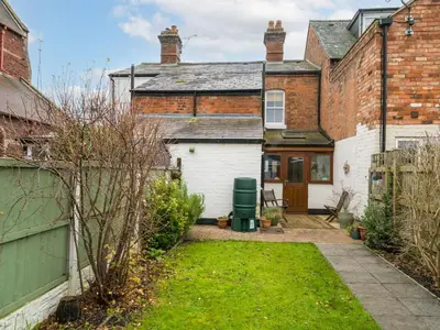 an exterior view of a house with a yard at Colourful homely 2 bed terrace - Pass the Keys in Shrewsbury