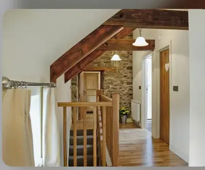 a room with a staircase in a house at Golygfar Mynydd in Ystrad Meurig